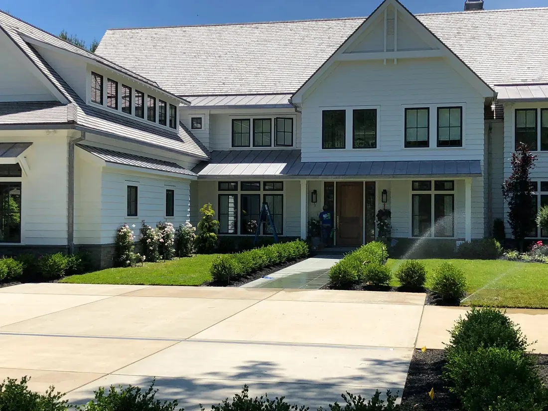 Newly finished modern farmhouse with clean windows and concrete