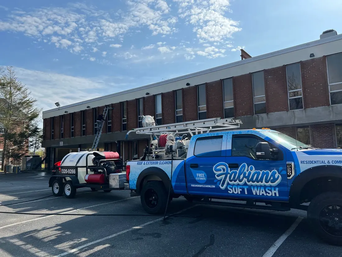 Fabian’s Soft Wash pickup and trailer rig at a commercial building