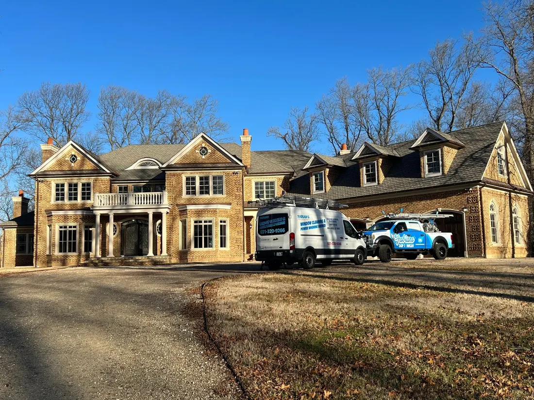 Fabian’s vans in the driveway of a stone manor