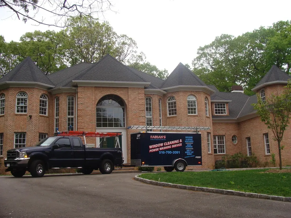 Fabian’s trailer and pickup at a brick home
