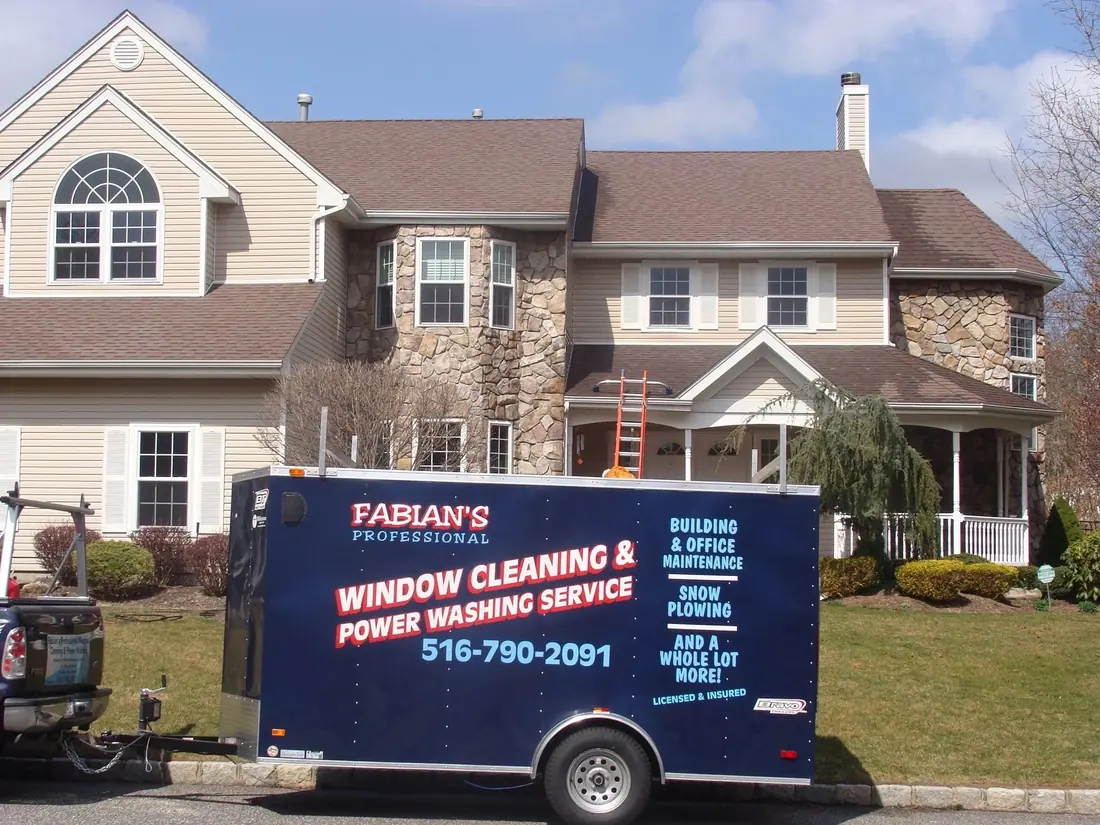 Fabian’s window cleaning and power washing trailer at a Long Island home