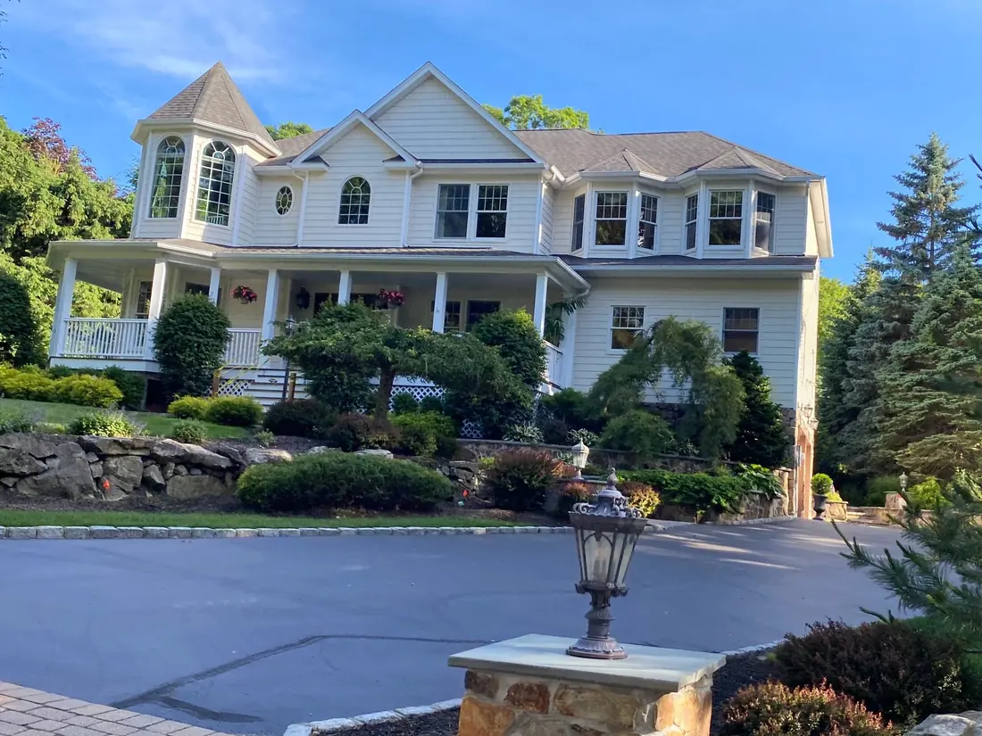 Large white Long Island home with clean gutters and trim